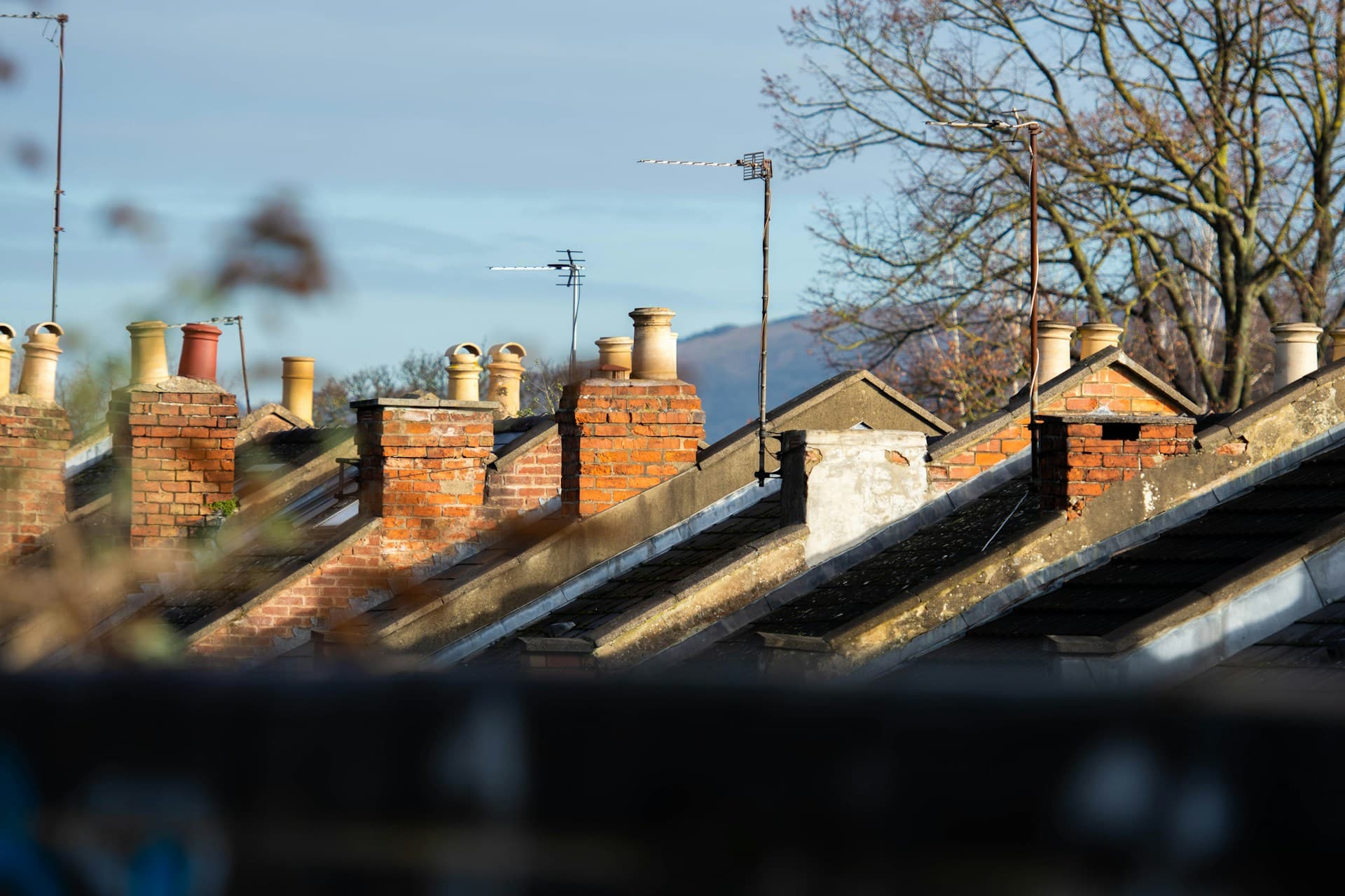 Chimney stack on a UK home requiring annual sweeping for a wood burning stove